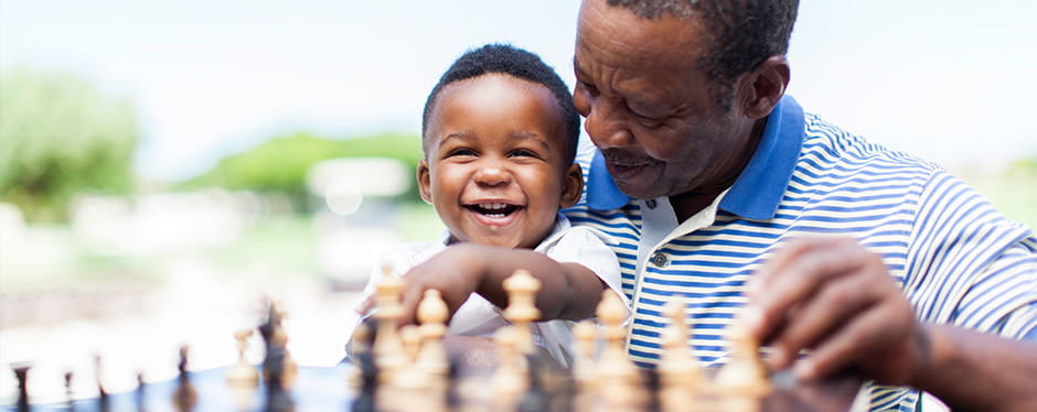 Image of man playing chess with grandson