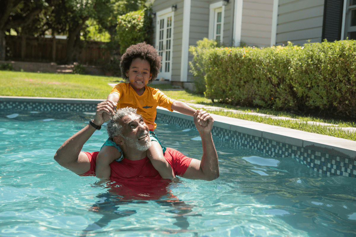 man with child in pool