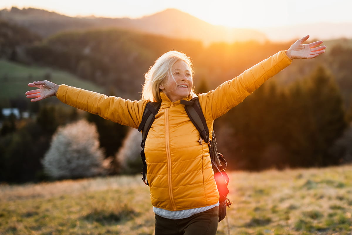 senior rejoicing in sunset